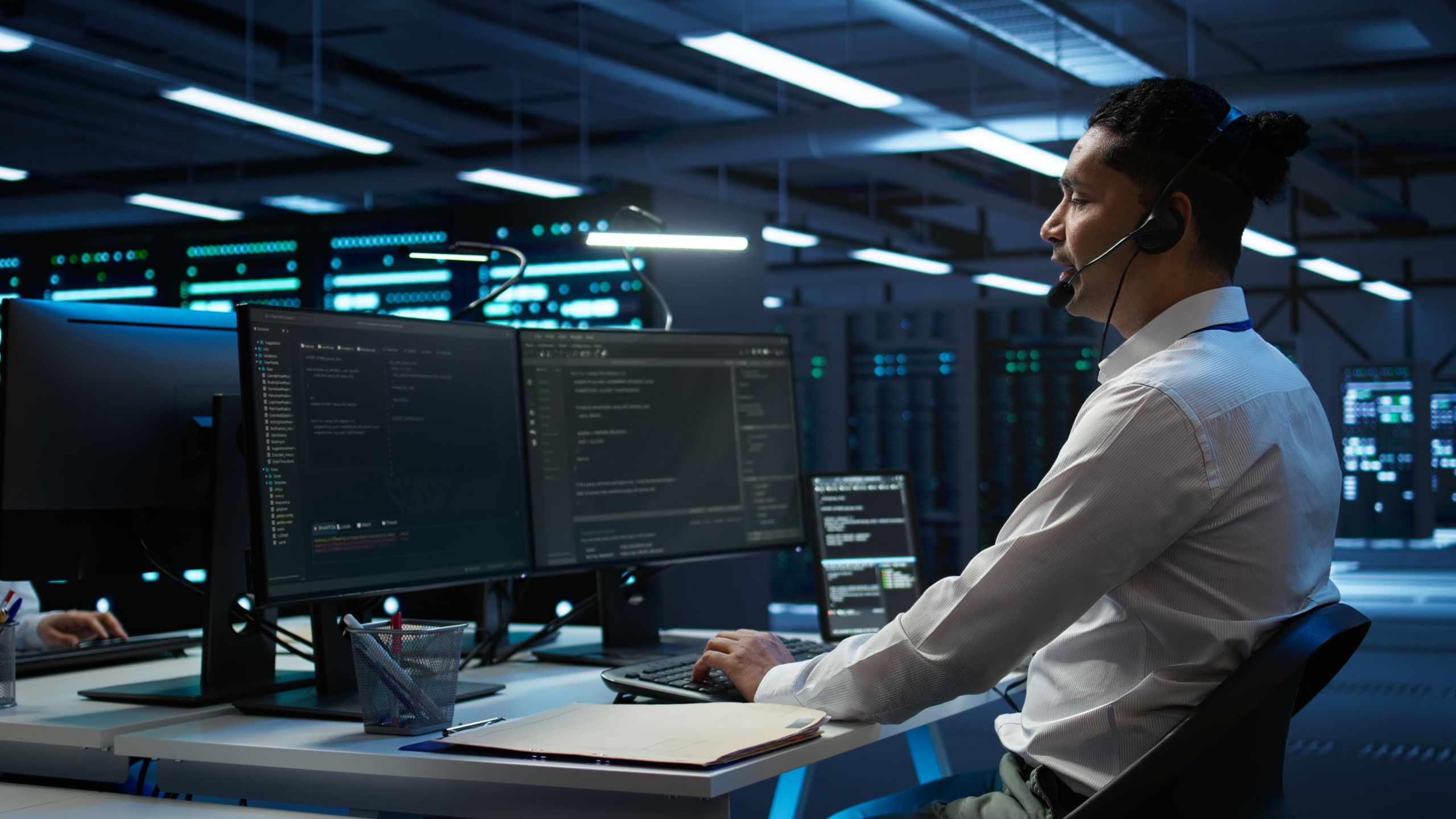 Team of IT professionals wearing headsets working in their stations.