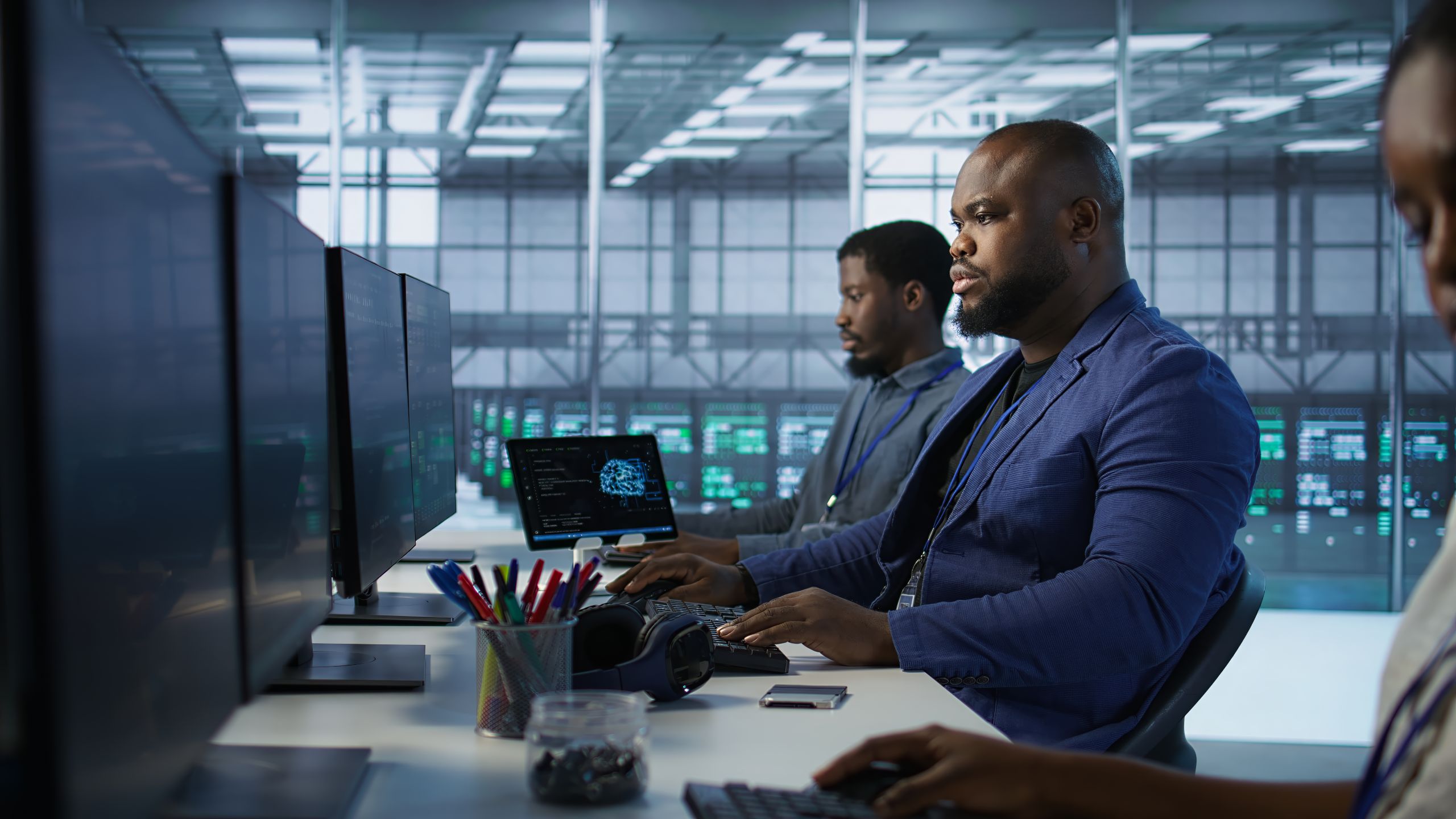 Two colleagues in front of a computer having discussion.