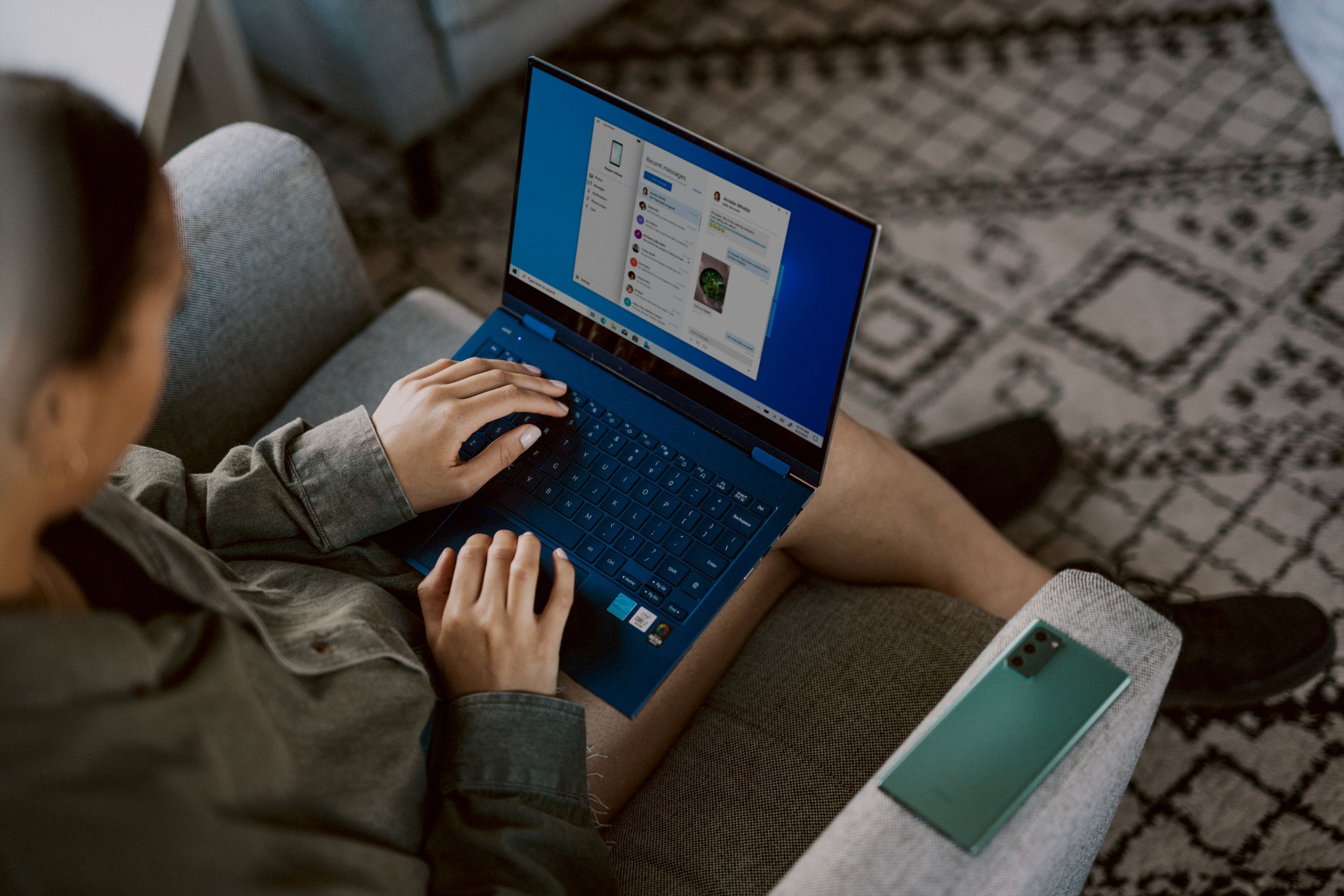 Overhead image of a person typing on a laptop.