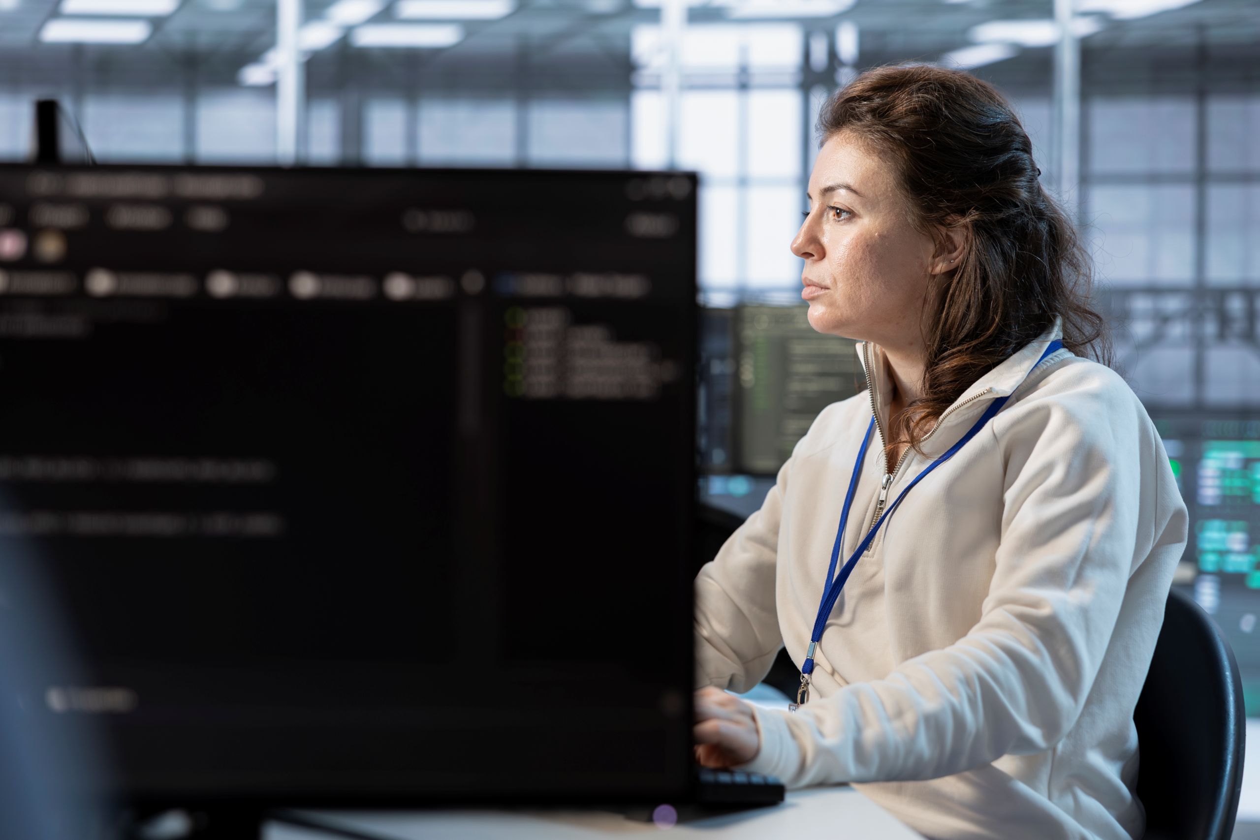 IT specialist working behind monitor.